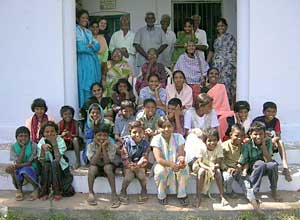 orphans and elderly on orphanage steps