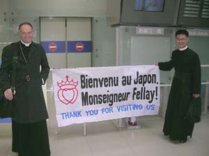 Bishop Fellay with Fr. Onoda and welcome banner